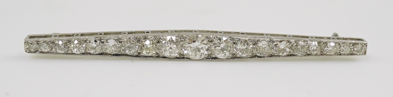 A 1920's platinum? and nineteen millegrain set graduated diamond bar brooch, 59mm, gross weight 4.6 grams. Condition - fair to good